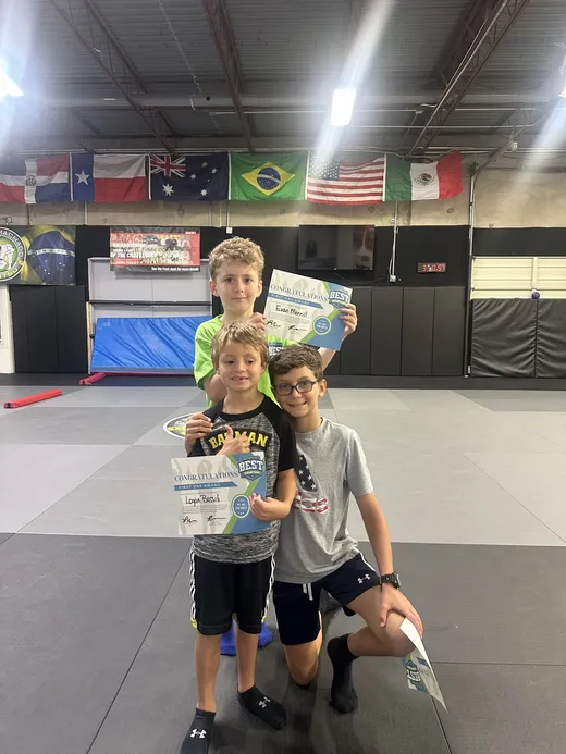 Campers holding up certificates they earned