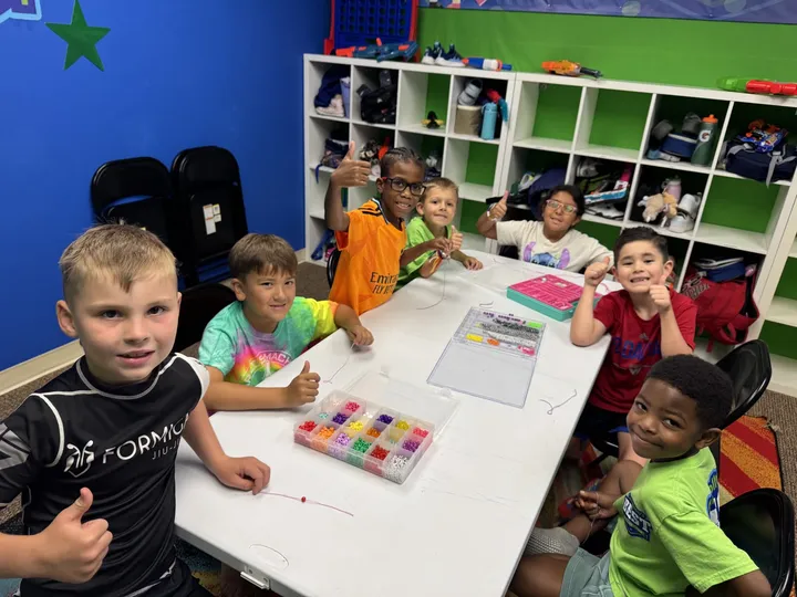 Campers working on a craft project at a shared table