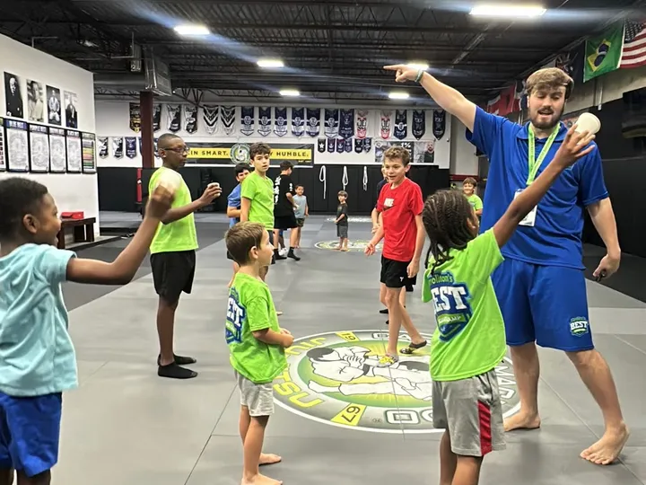 Campers playing an active game together in the gym