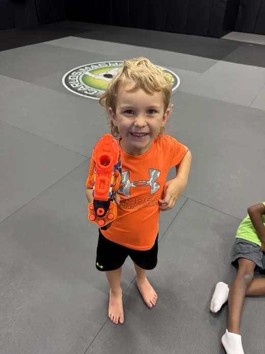 A camper with a foam blaster during an active game