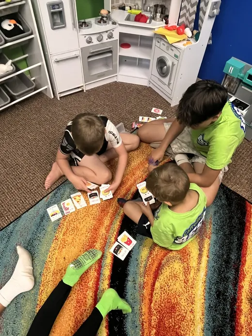 Younger campers playing in the play kitchen area