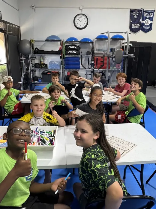 Campers gathered around activity tables