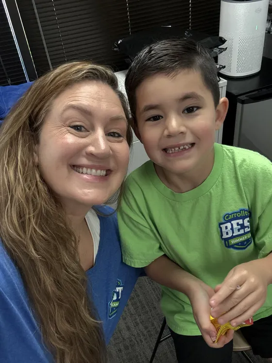 A Carrollton's BEST staff member with a camper